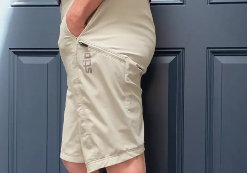 Side view of woman wearing Stio OPR Shorts